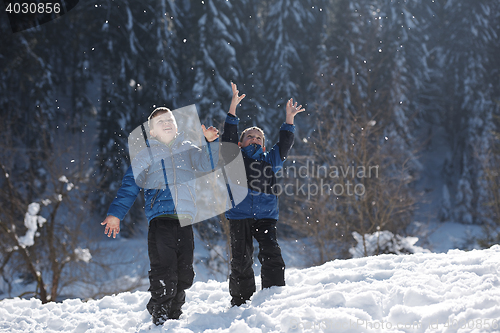 Image of kids playing with  fresh snow