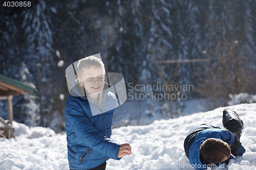 Image of kids playing with  fresh snow