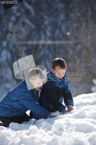 Image of kids playing with  fresh snow