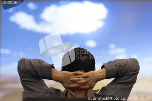 Image of young man dreaming clouds on presentation