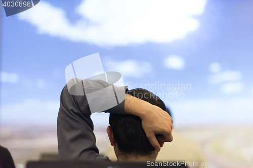 Image of young man dreaming clouds on presentation