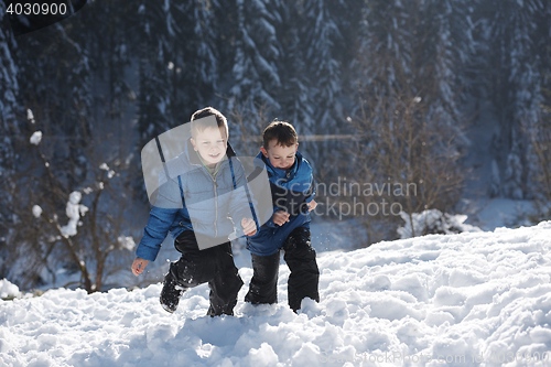 Image of kids playing with  fresh snow