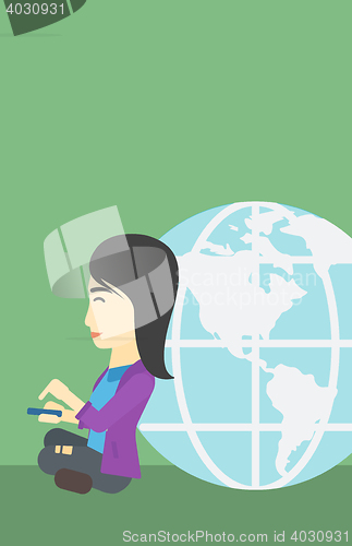 Image of Businessman sitting near Earth globe.