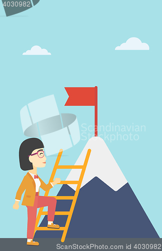 Image of Business woman climbing on mountain.