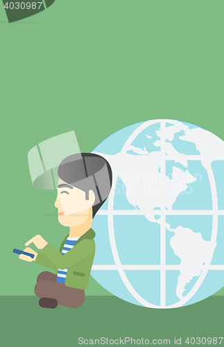 Image of Businessman sitting near Earth globe.