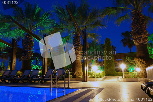 Image of Swimming pool on summer beach by night