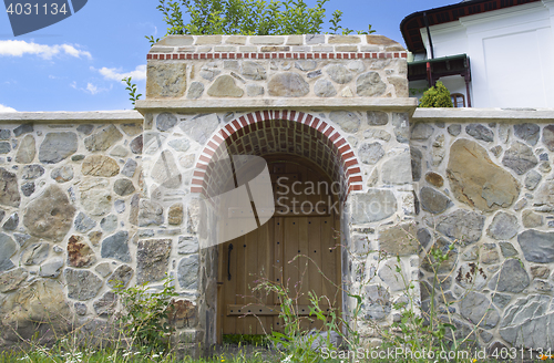 Image of Wood gate and stone wall