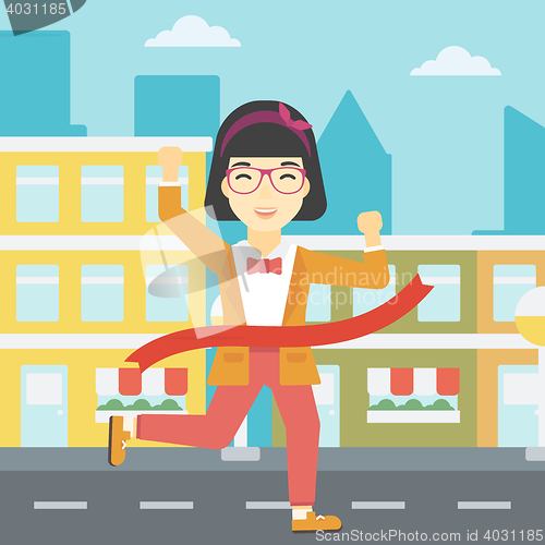 Image of Business woman crossing finish line.