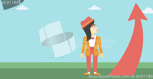 Image of Business woman looking at arrow going up.
