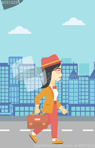 Image of Successful business woman walking with briefcase.