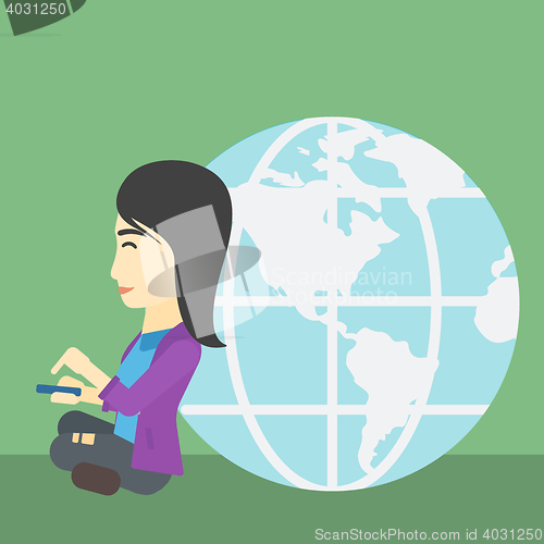 Image of Businessman sitting near Earth globe.