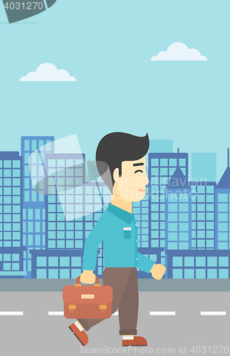 Image of Successful businessman walking with briefcase.