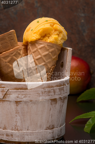 Image of Homemade mango ice cream in waffle cone