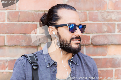 Image of happy man with earphones listening to music