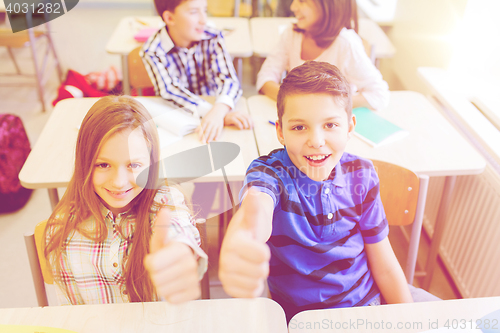 Image of group of school kids showing thumbs up