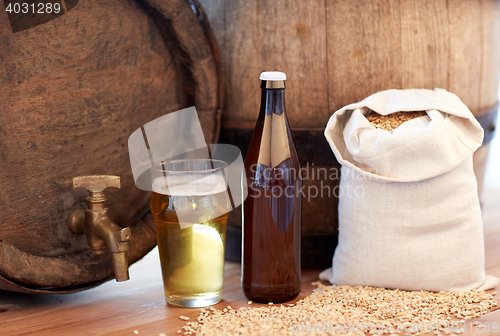 Image of close up of beer barrel, glass, bottle and malt