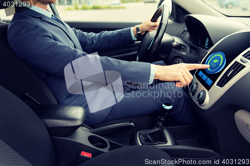 Image of close up of man  driving car in eco mode