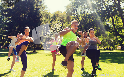 Image of group of friends or sportsmen exercising outdoors