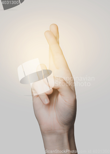 Image of close up of hand showing two cross fingers