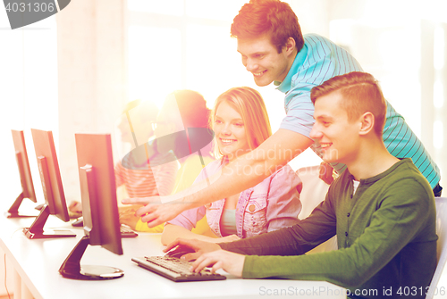 Image of smiling students in computer class at school