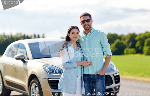 Image of happy man and woman hugging at car