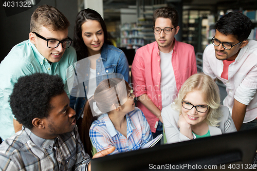 Image of international students with computers at library