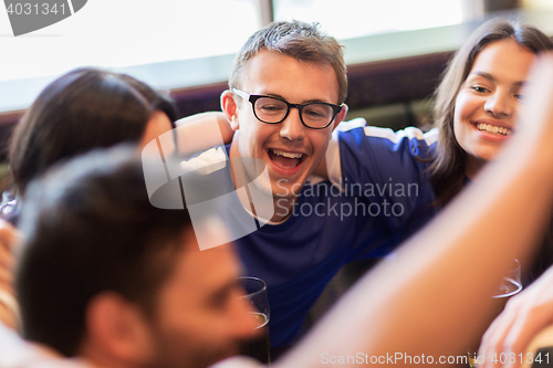 Image of football fans or friends with beer at sport bar
