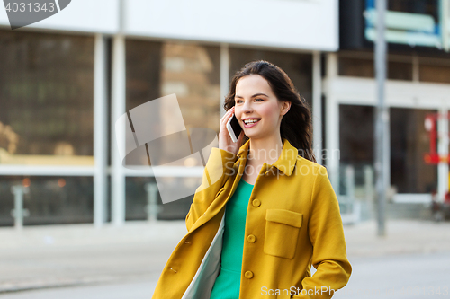 Image of smiling young woman or girl calling on smartphone