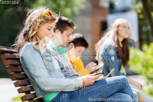 Image of happy girl with tablet pc computer outdoors