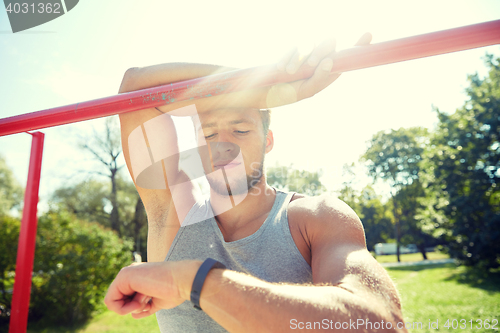 Image of man with heart-rate watch exercising outdoors