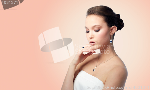 Image of beautiful woman with earring, ring and pendant