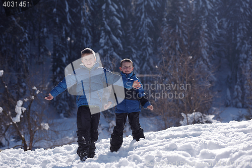 Image of kids playing with  fresh snow