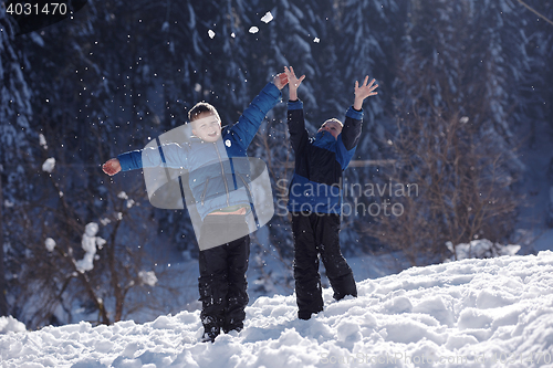 Image of kids playing with  fresh snow