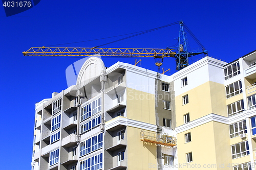 Image of modern skyscraper with hoisting crane