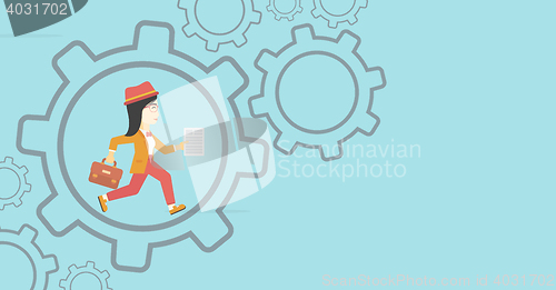 Image of Business woman running inside the gear.