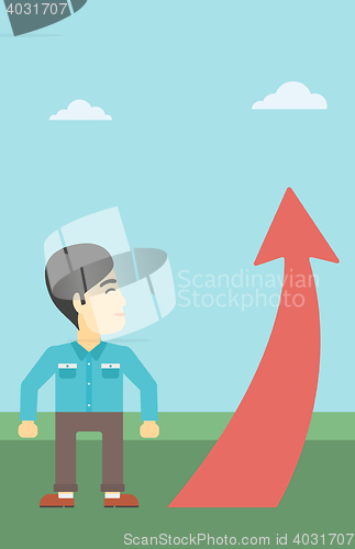 Image of Businessman looking at arrow going up.