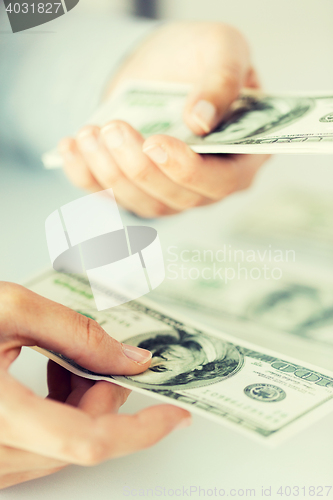 Image of close up of woman hands counting us dollar money