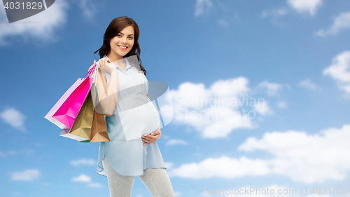 Image of happy pregnant woman with shopping bags