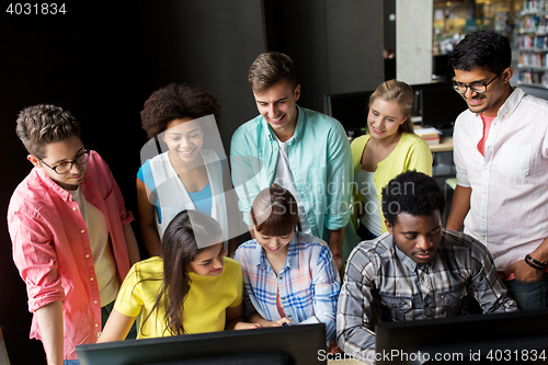 Image of international students with computers at library