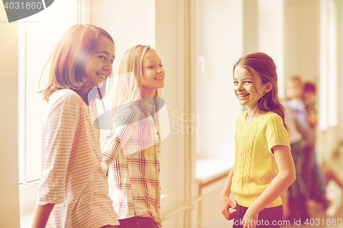 Image of group of smiling school kids in corridor