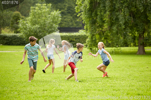 Image of happy kids running and playing game outdoors