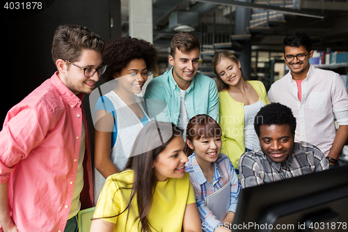 Image of international students with computers at library