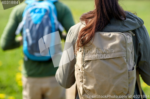 Image of close up of couple with backpacks hiking outdoors