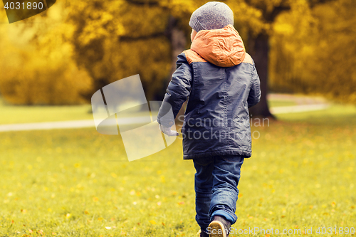 Image of little boy running outdoors