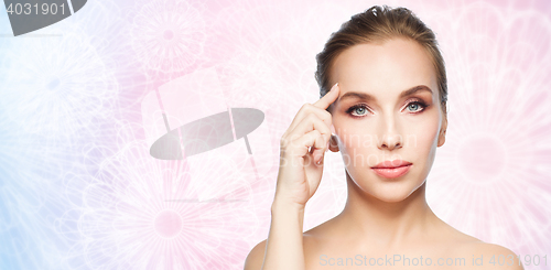 Image of beautiful young woman showing her forehead