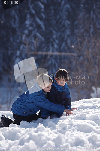 Image of kids playing with  fresh snow