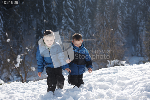 Image of kids playing with  fresh snow