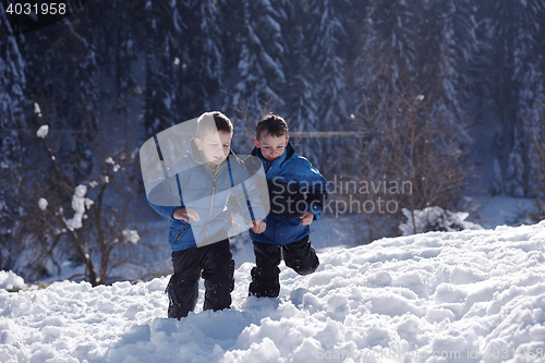 Image of kids playing with  fresh snow