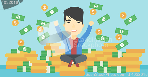 Image of Happy businessman sitting on coins.