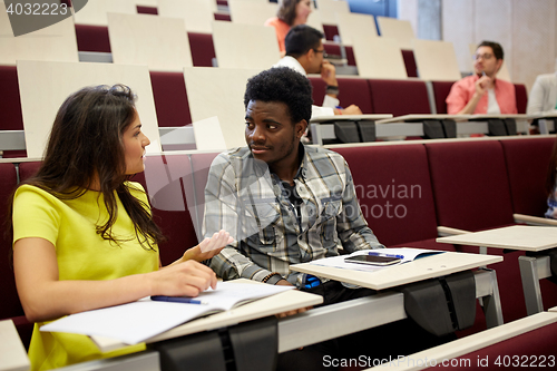 Image of group of students with notebooks at lecture hall